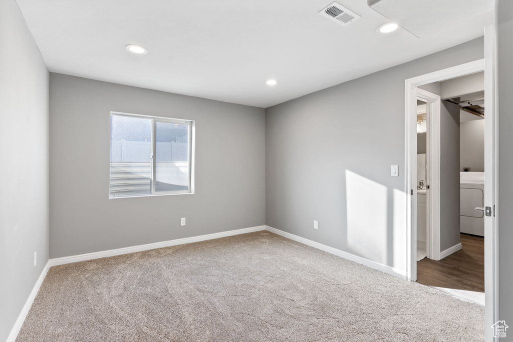 Spare room featuring washer / dryer and carpet flooring