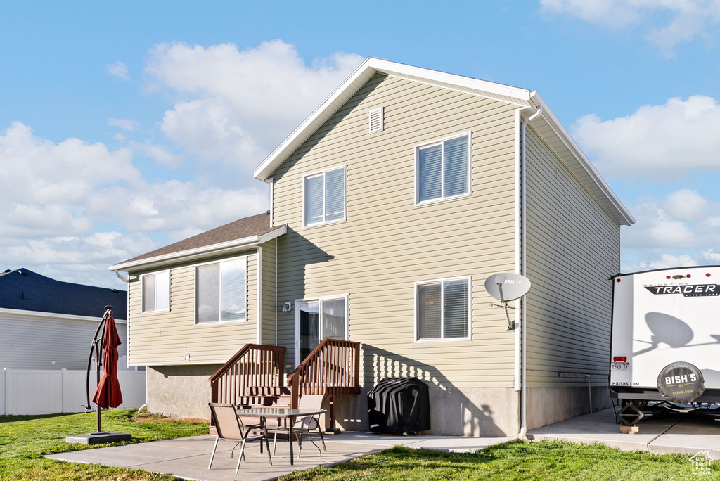 Back of house with a patio area