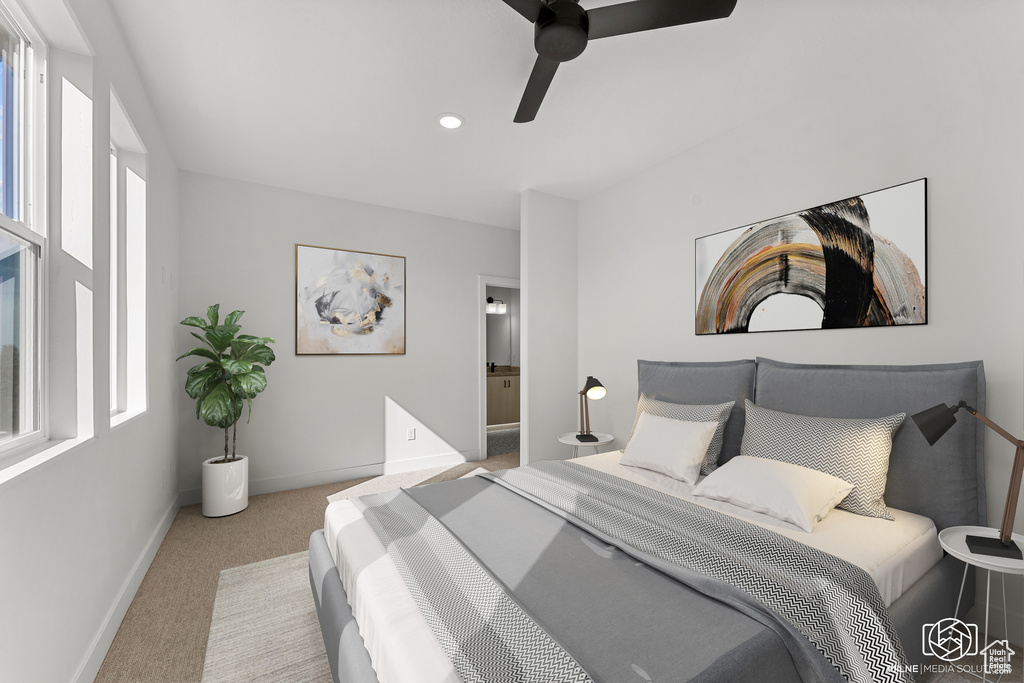 Bedroom featuring light carpet, ensuite bath, and ceiling fan