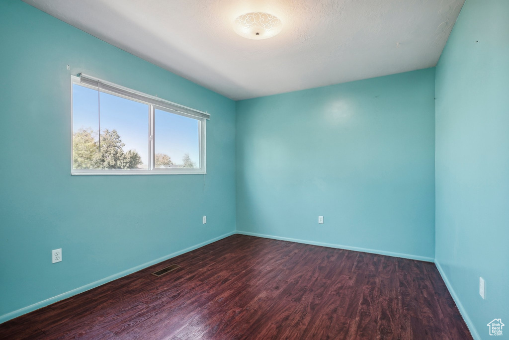 Spare room featuring hardwood / wood-style floors