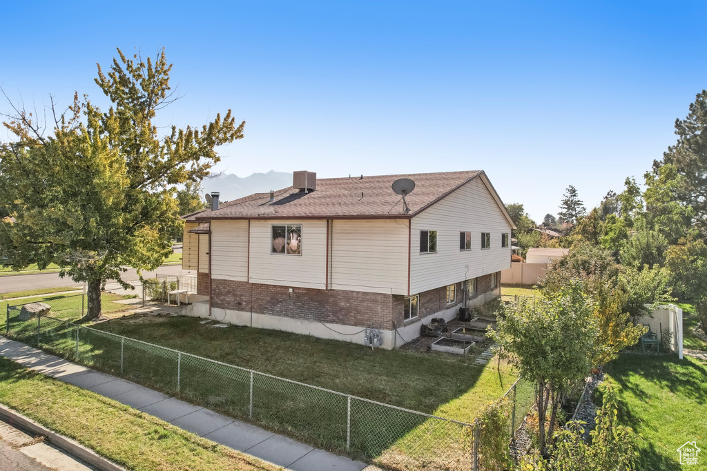 View of home's exterior with a yard