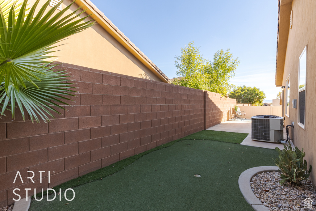 View of yard featuring cooling unit and a patio area