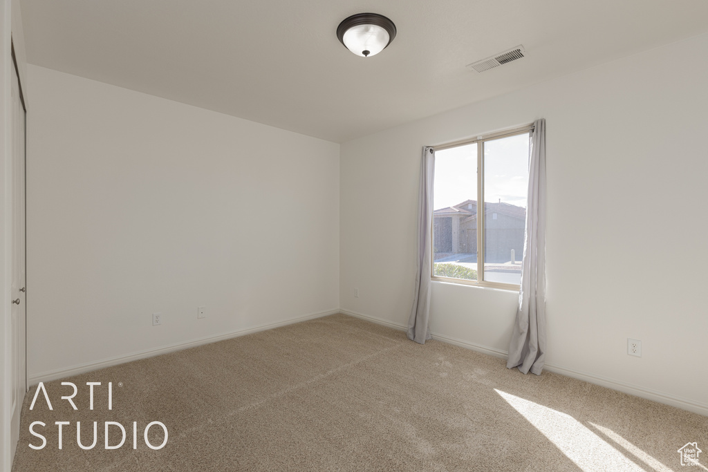 Unfurnished room with light colored carpet