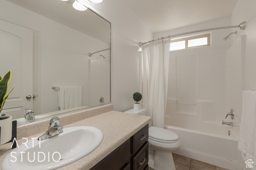 Full bathroom with vanity, shower / tub combo with curtain, toilet, and tile patterned flooring