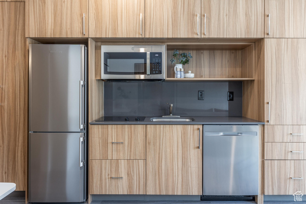 Kitchen featuring sink, light brown cabinets, and stainless steel appliances