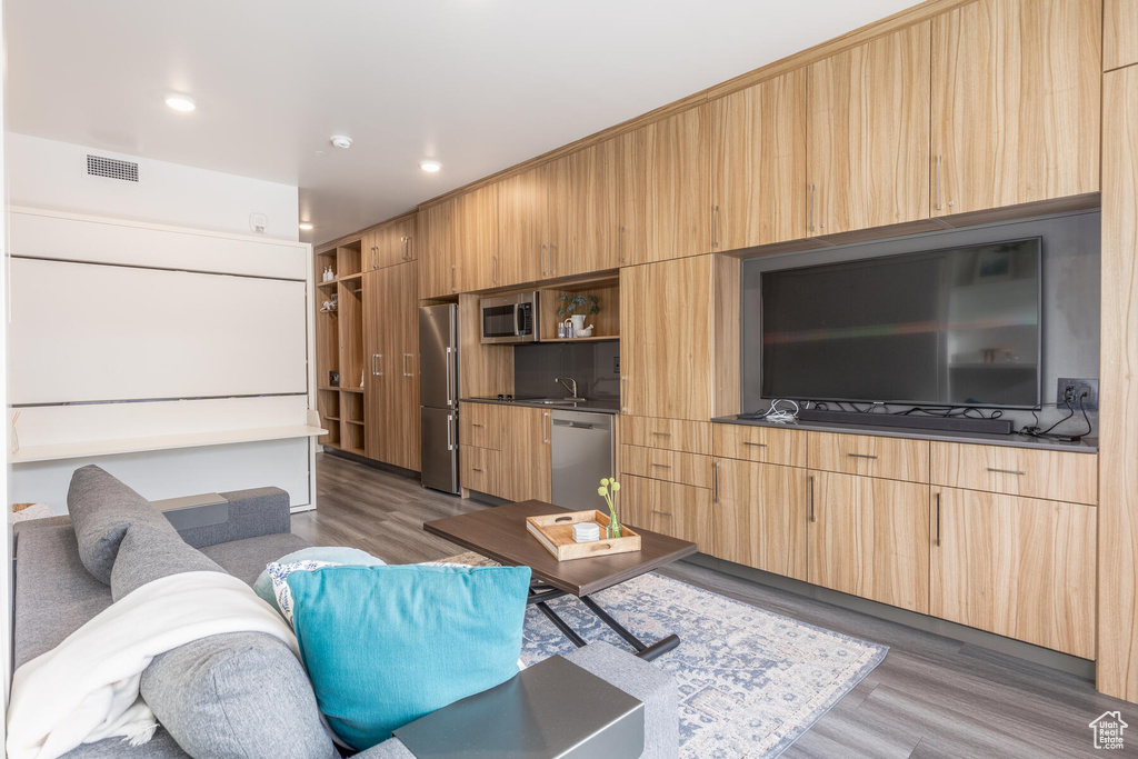 Living room featuring sink and dark hardwood / wood-style flooring