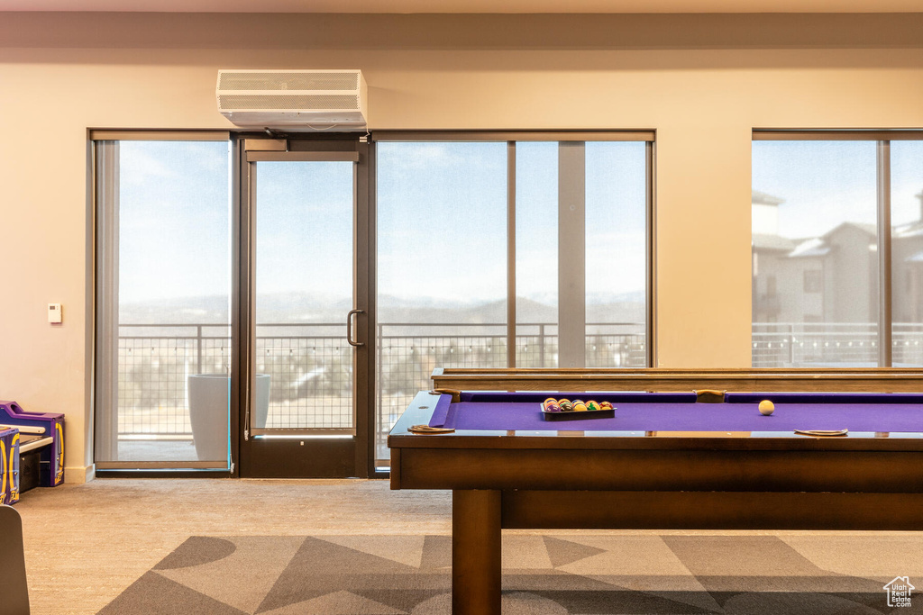 Playroom with a wall mounted AC, carpet flooring, and pool table