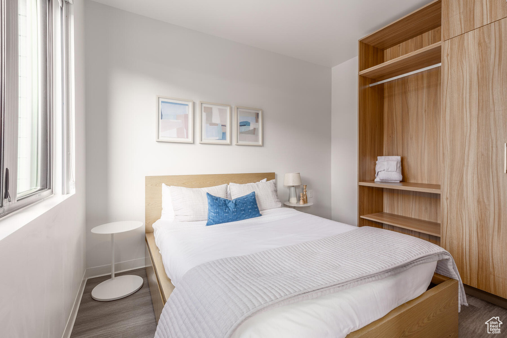 Bedroom with dark wood-type flooring