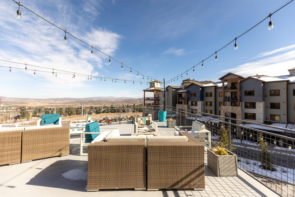 View of patio with a mountain view and a balcony