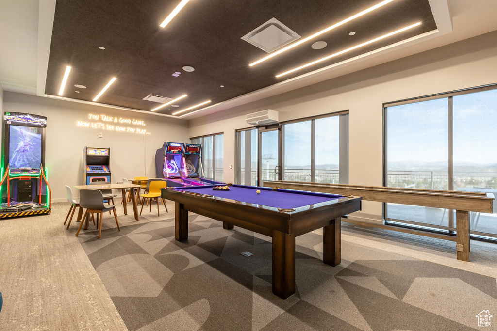 Rec room featuring a wall unit AC, carpet, pool table, and a tray ceiling