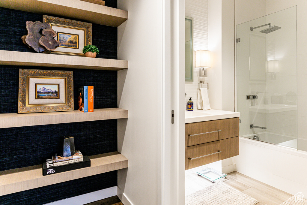 Bathroom featuring vanity, hardwood / wood-style flooring, and shower / bathtub combination