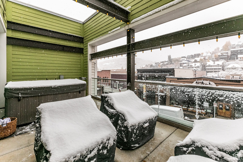 View of snow covered back of property