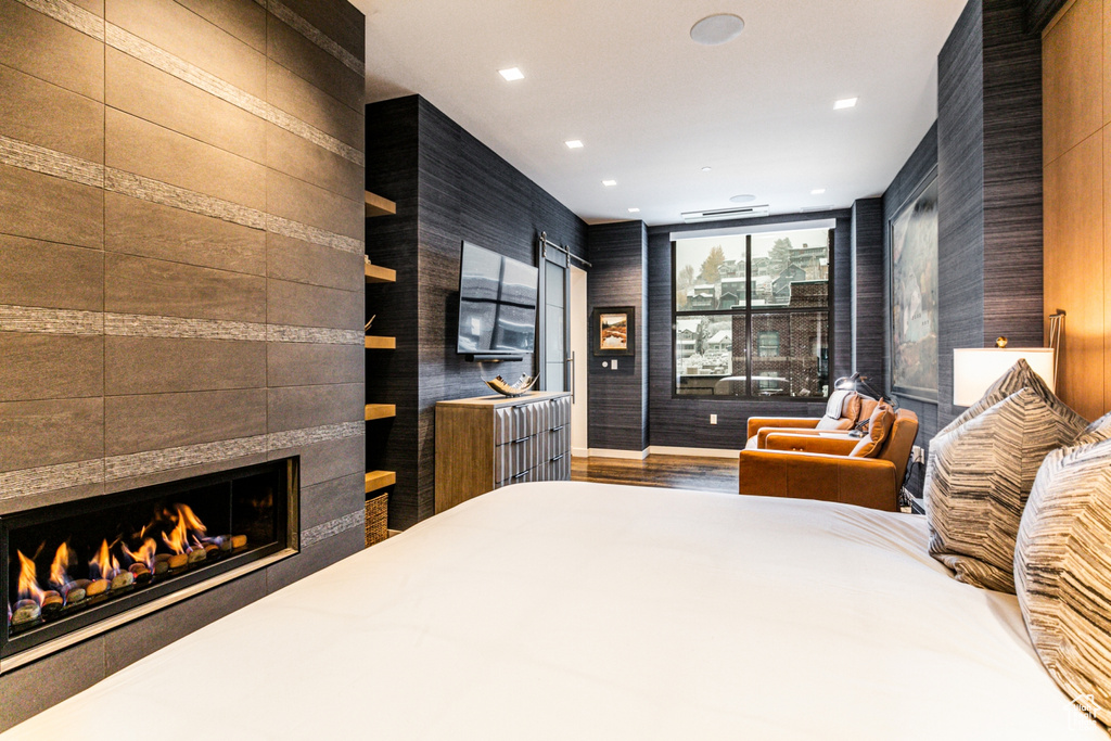 Bedroom featuring a tile fireplace