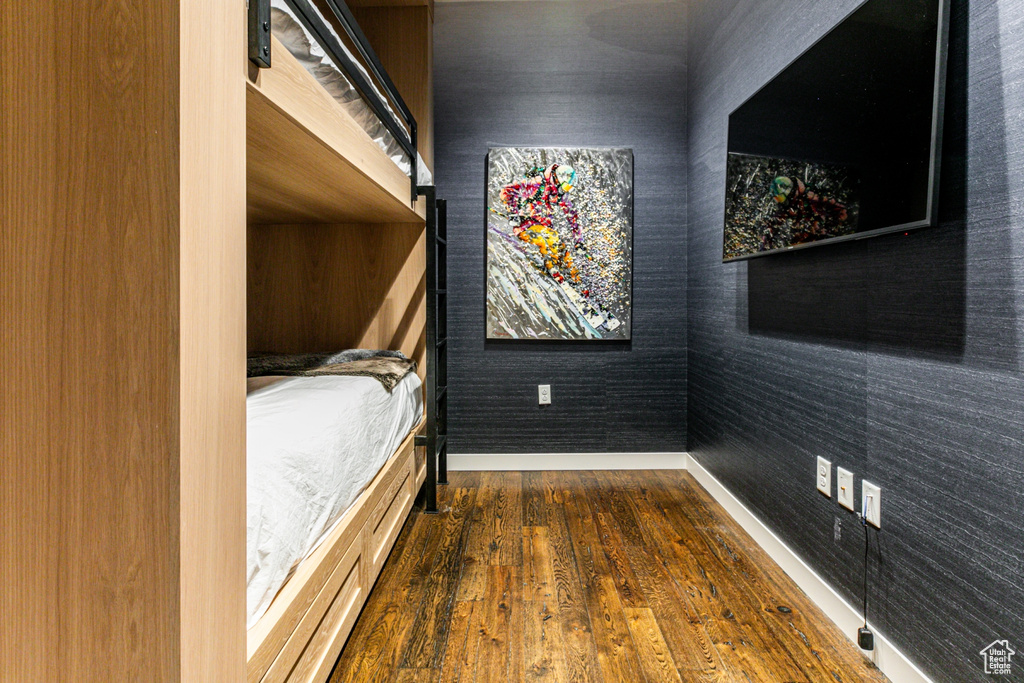 Unfurnished bedroom with dark hardwood / wood-style flooring