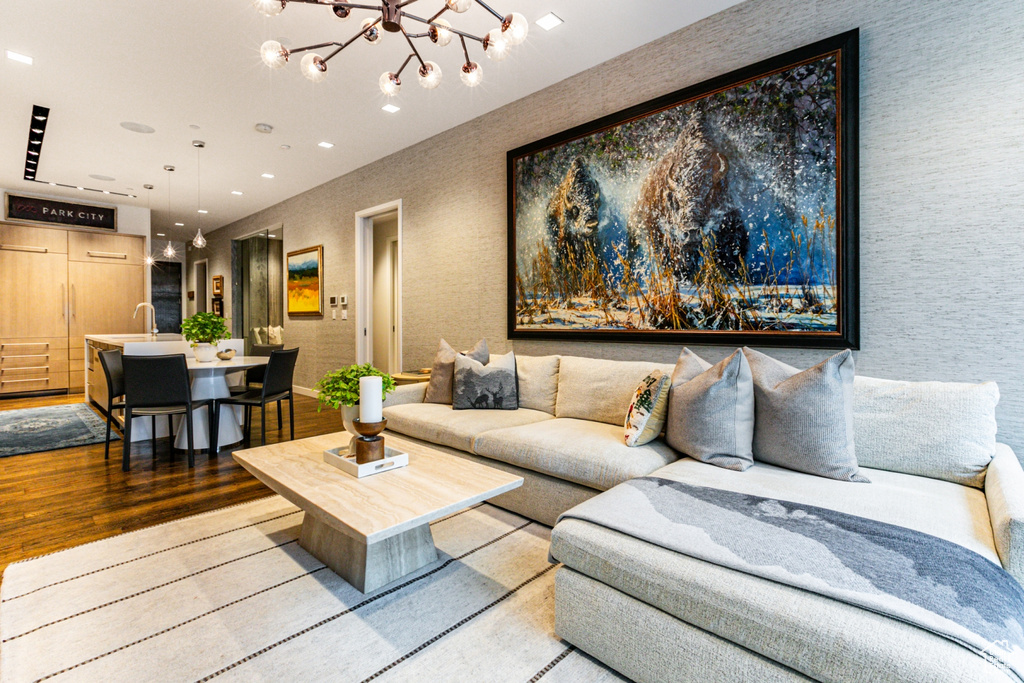 Living room featuring hardwood / wood-style floors and a notable chandelier