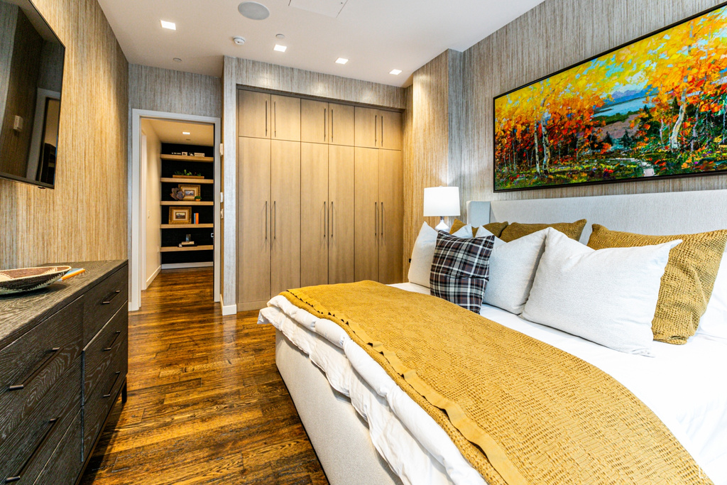 Bedroom featuring a closet and dark hardwood / wood-style flooring