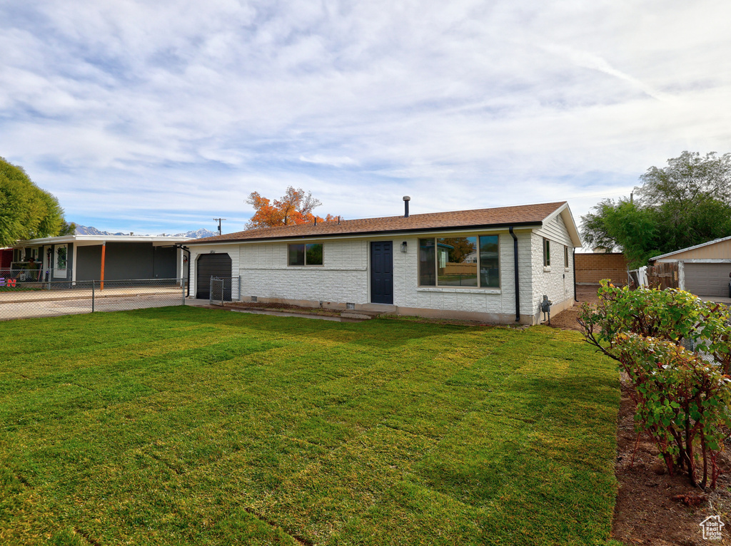 Single story home featuring a front lawn