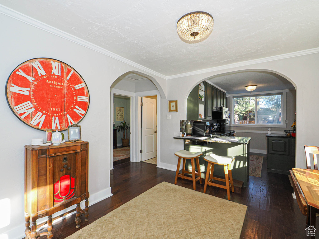 Dining area featuring crown molding and dark hardwood / wood-style floors