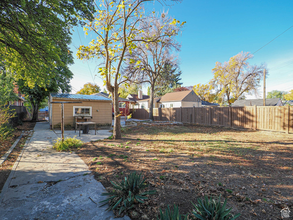 View of yard with a shed and a patio area