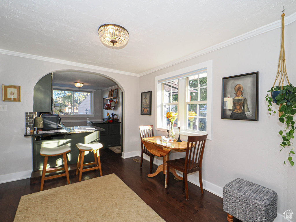 Dining room featuring crown molding and dark hardwood / wood-style floors