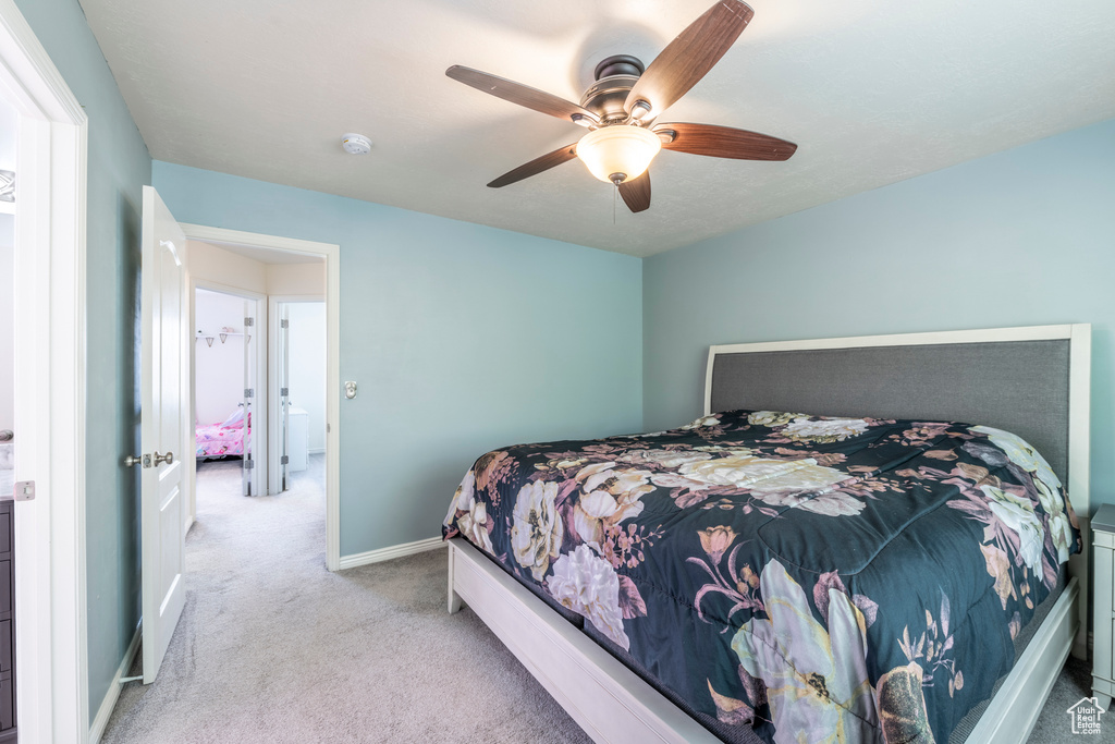 Bedroom featuring light colored carpet and ceiling fan