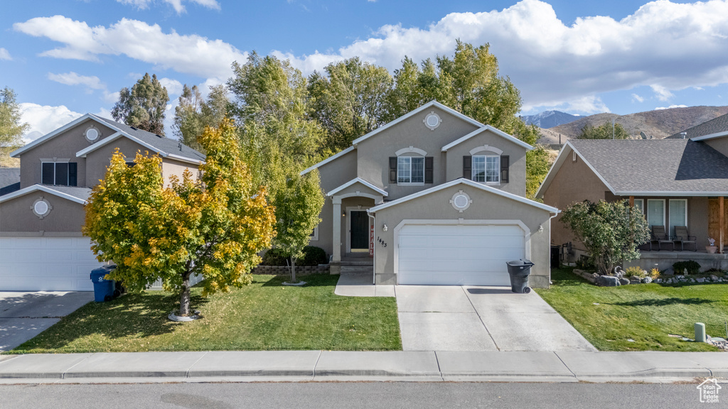 Front facade with a mountain view and a front lawn