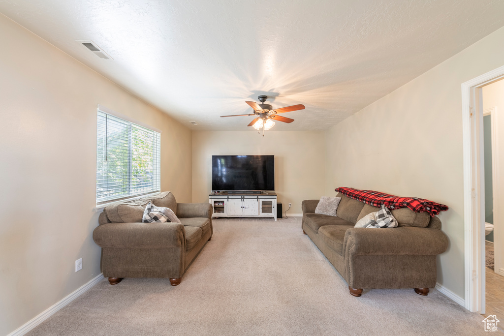 Living room with light carpet and ceiling fan