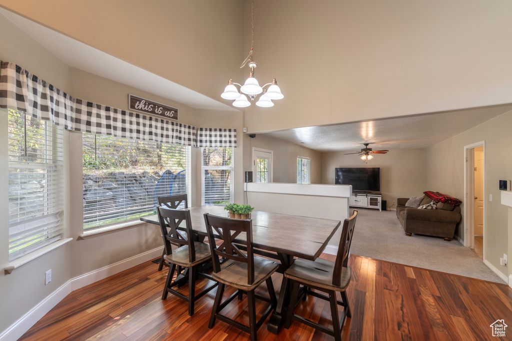 Dining room featuring hardwood / wood-style flooring and ceiling fan with notable chandelier