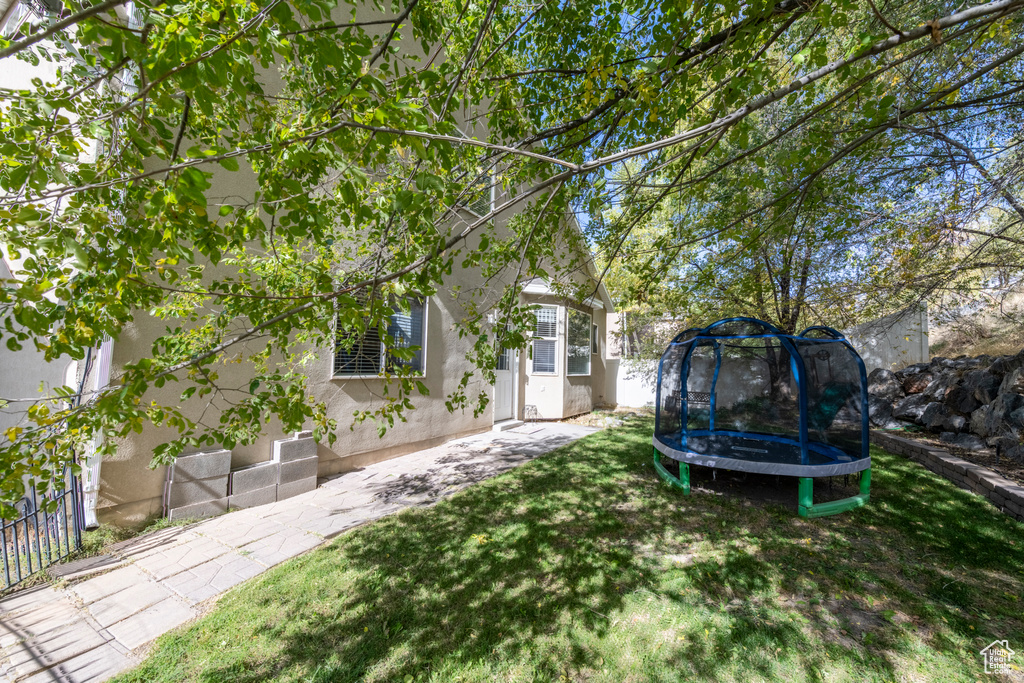 View of yard featuring a trampoline