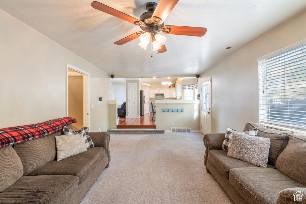 Living room with light carpet and ceiling fan