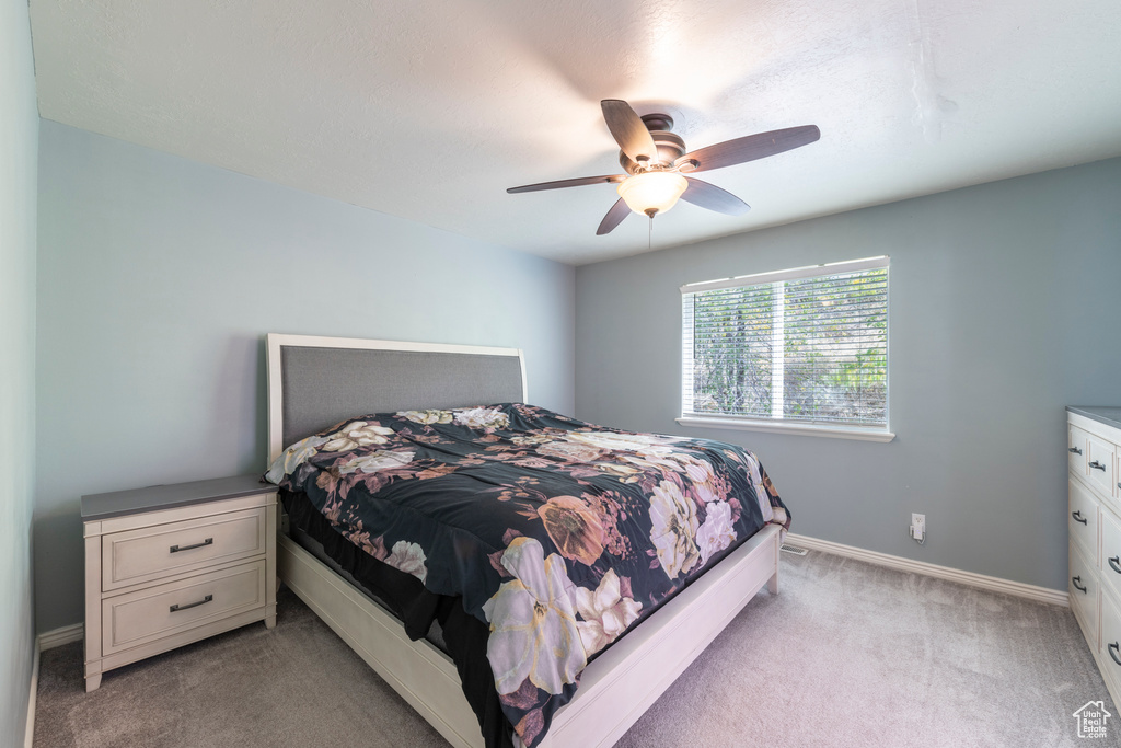 Carpeted bedroom with ceiling fan