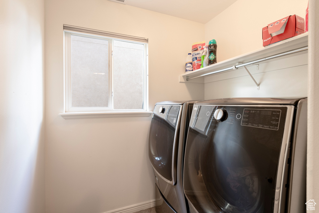 Washroom featuring independent washer and dryer