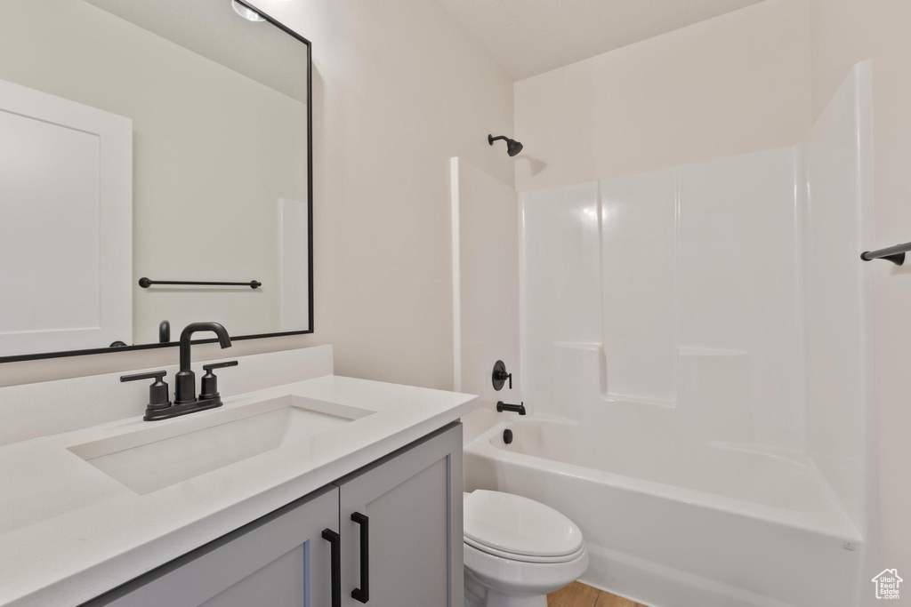 Full bathroom featuring vanity, shower / bathing tub combination, and toilet