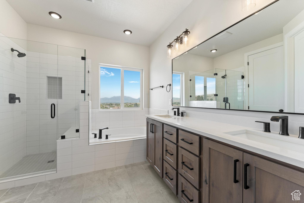 Bathroom with vanity, tile patterned floors, and separate shower and tub