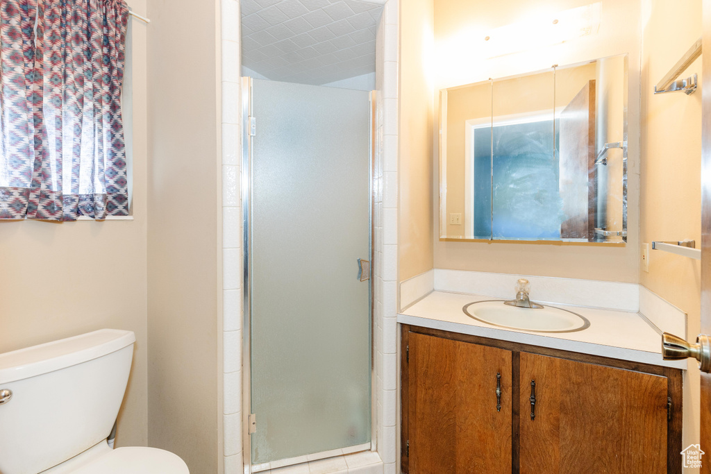 Bathroom with vanity, toilet, and walk in shower