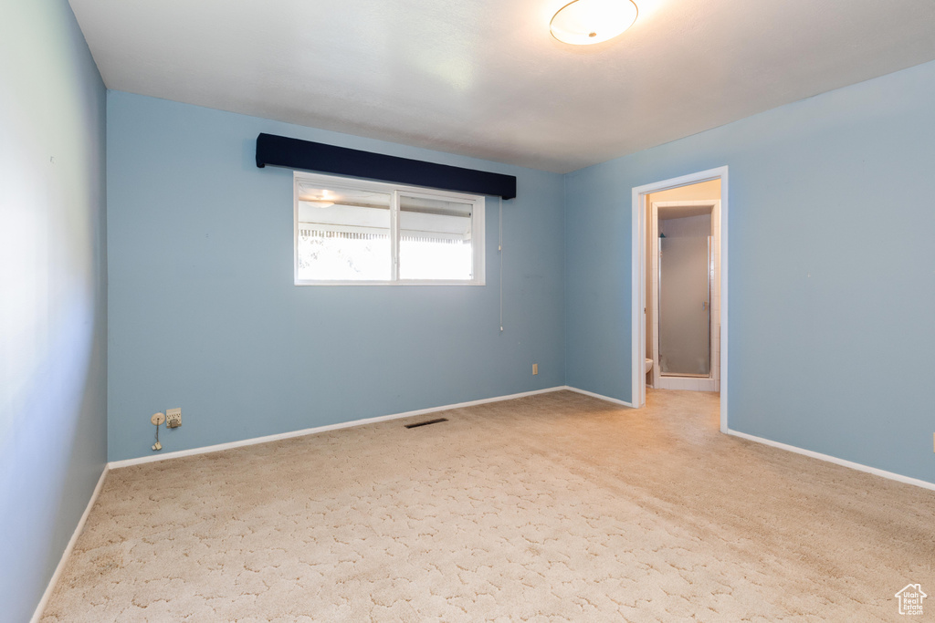 Unfurnished room with light colored carpet