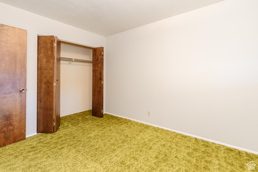 Unfurnished bedroom with a closet and carpet