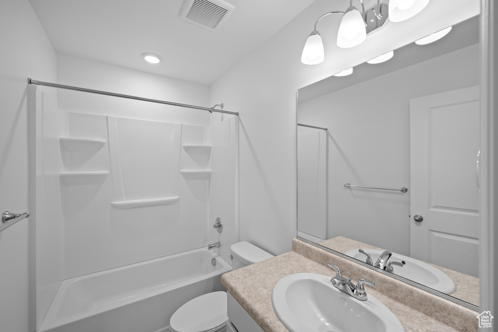 Bathroom featuring vanity, toilet, and tub / shower combination