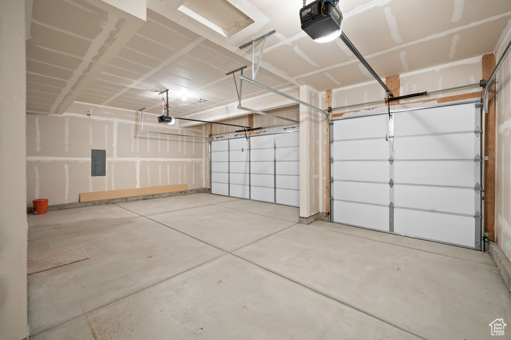 Garage with electric panel and a garage door opener
