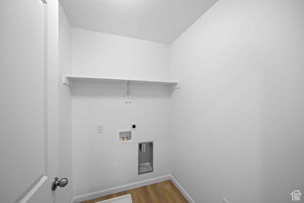 Washroom featuring light wood-style floors, baseboards, electric dryer hookup, and hookup for a washing machine