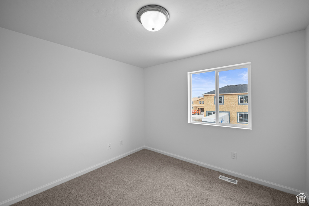 Unfurnished room featuring baseboards and carpet