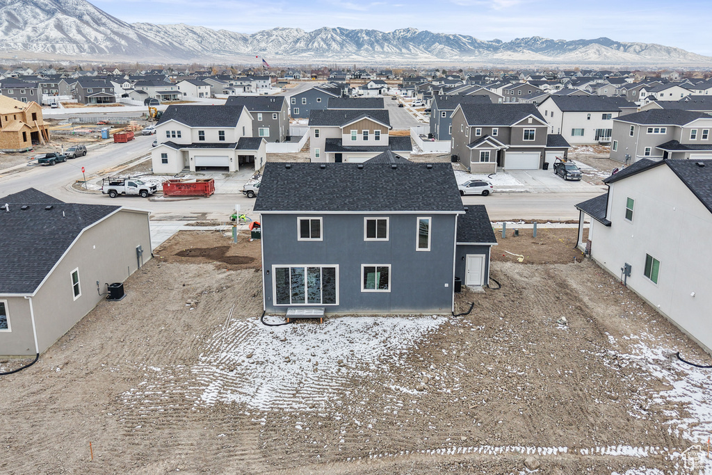 Aerial view of residential area featuring a mountainous background