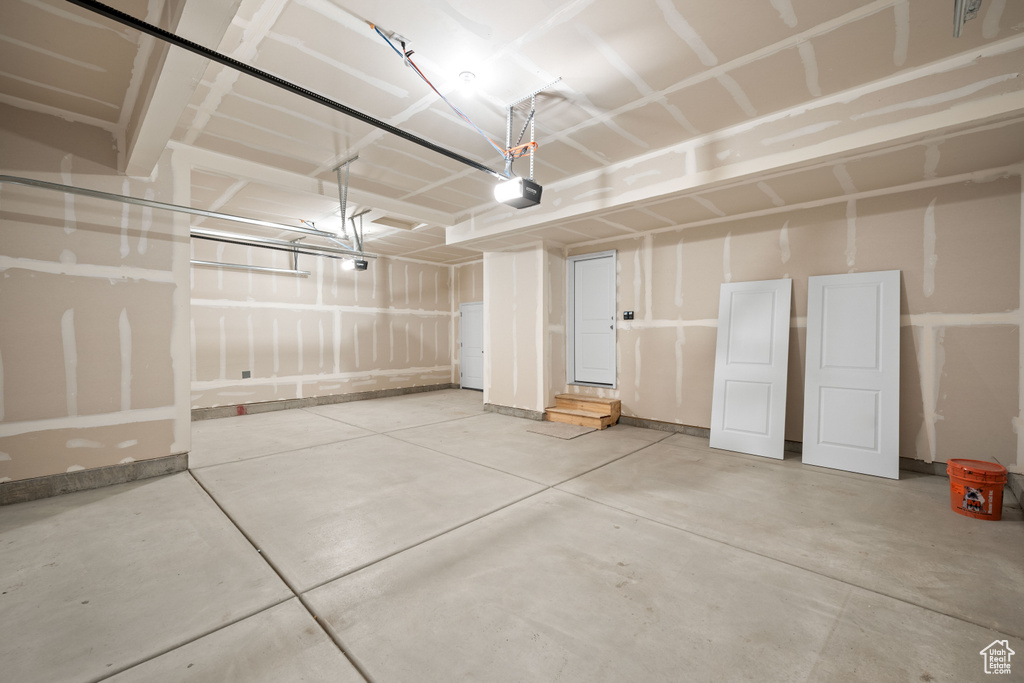 Garage featuring a garage door opener