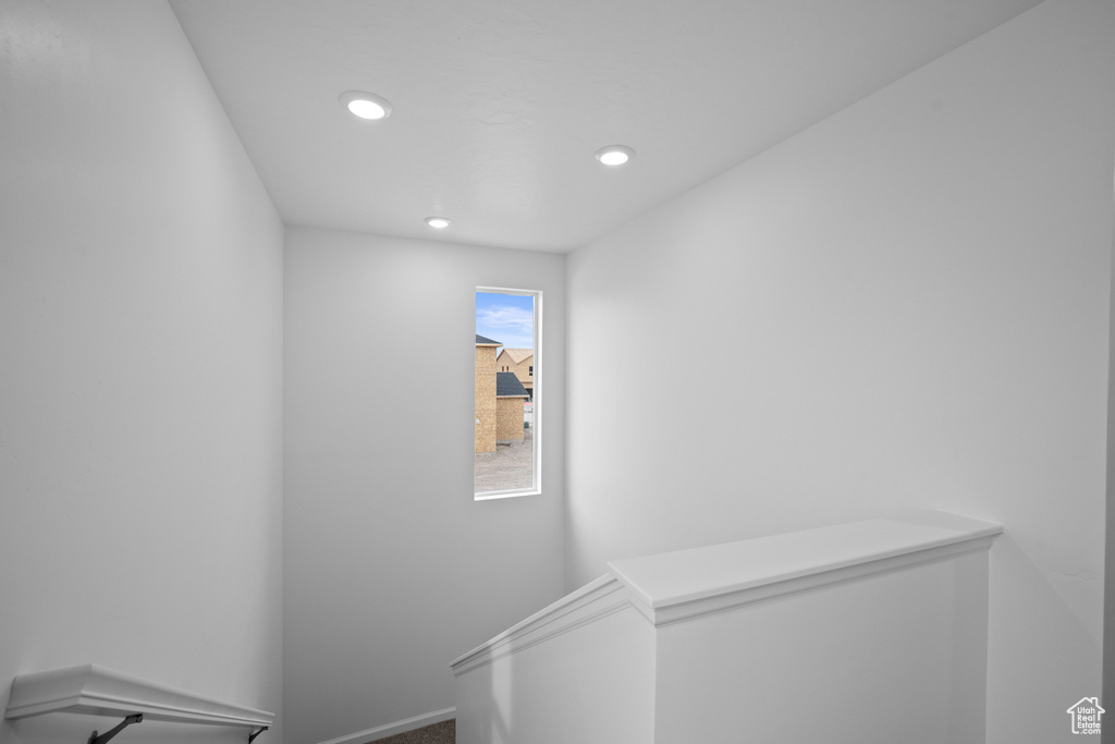 Staircase with recessed lighting and carpet flooring