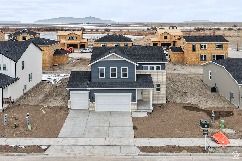 Aerial view of residential area featuring a mountainous background