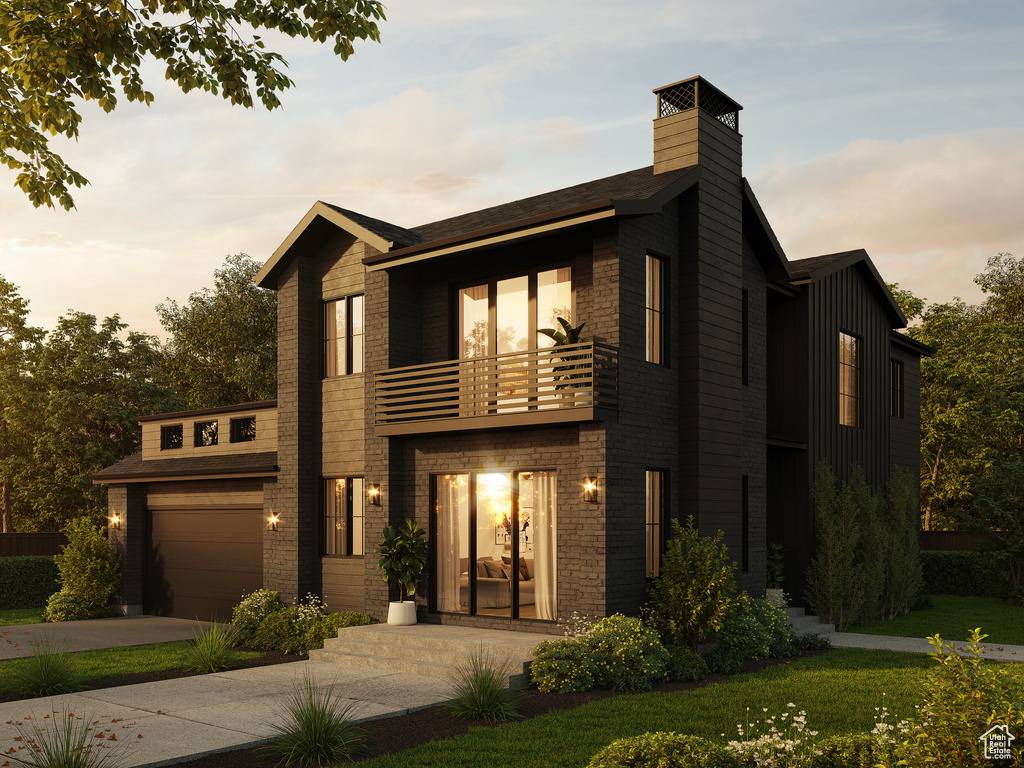 Contemporary house featuring a garage, a lawn, and a balcony