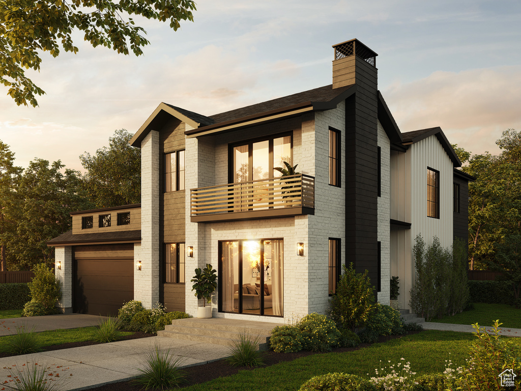 Contemporary home featuring a lawn, a balcony, and a garage