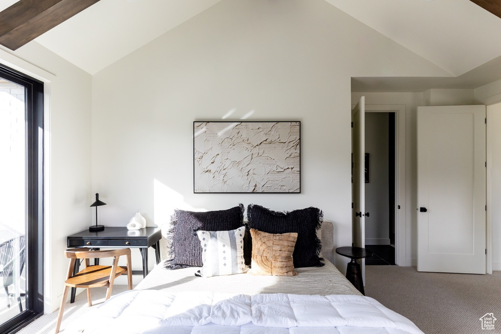 Bedroom featuring carpet and vaulted ceiling