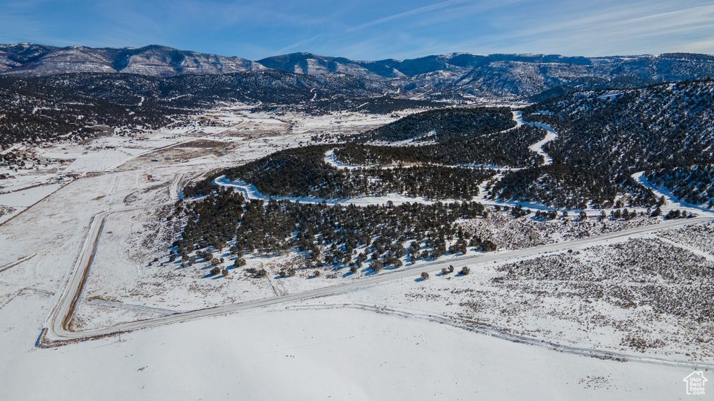 Snowy aerial view featuring a mountain view