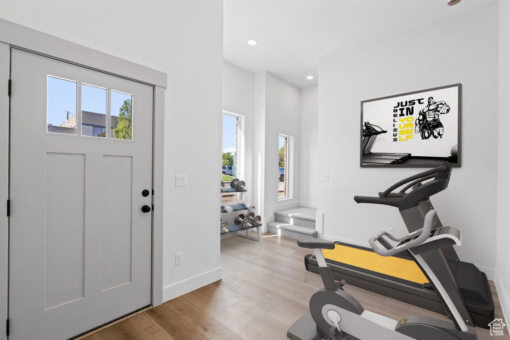 Exercise room with plenty of natural light, baseboards, light wood-type flooring, and recessed lighting
